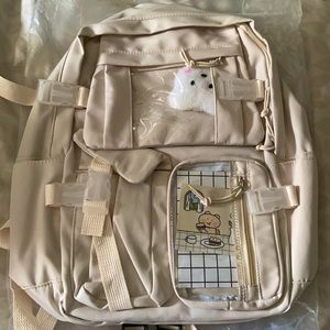 Cream colored backpack.